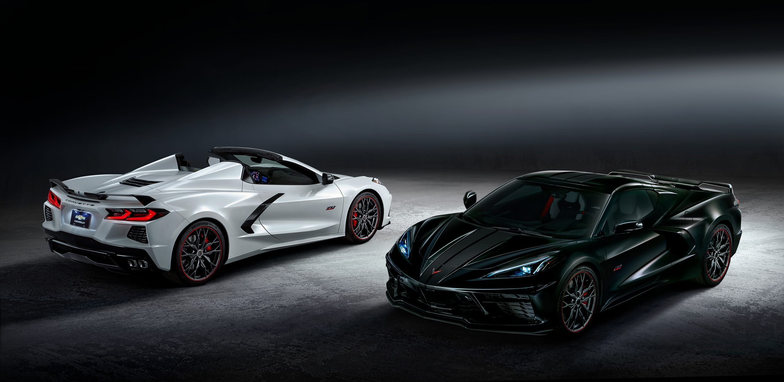 The 2023 Chevrolet Corvette Stingray convertible and coupe finished in White Pearl Metallic Tri-coat and Carbon Flash Metallic, respectively.